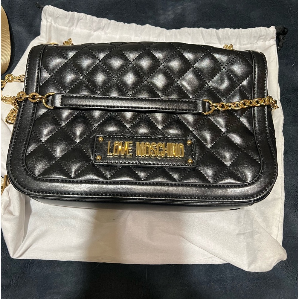 Moschino shoulder bag that is genuine leather and black in color.